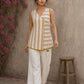 Charming white and mustard sleeveless wrap top featuring a distinctive Block print pattern, elegant mustard piping, and a graceful, contemporary, artisan-inspired tailored silhouette.