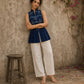 Contemporary indigo top with delicate dragonfly motifs, high folded collar, and graceful pleated hemline.