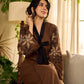 Brown block print dress with floral block printed flared sleeves, black tie-up neckline, and contrast black accents for an effortless, elegant everyday look.