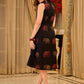 Statement black sleeveless shirt dress showcasing elephant-inspired prints and polka dots, highlighted with maroon accents.
