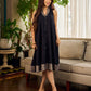 Modern black bias-cut dress showcasing unique artisan-inspired Kalamkari neck trim.