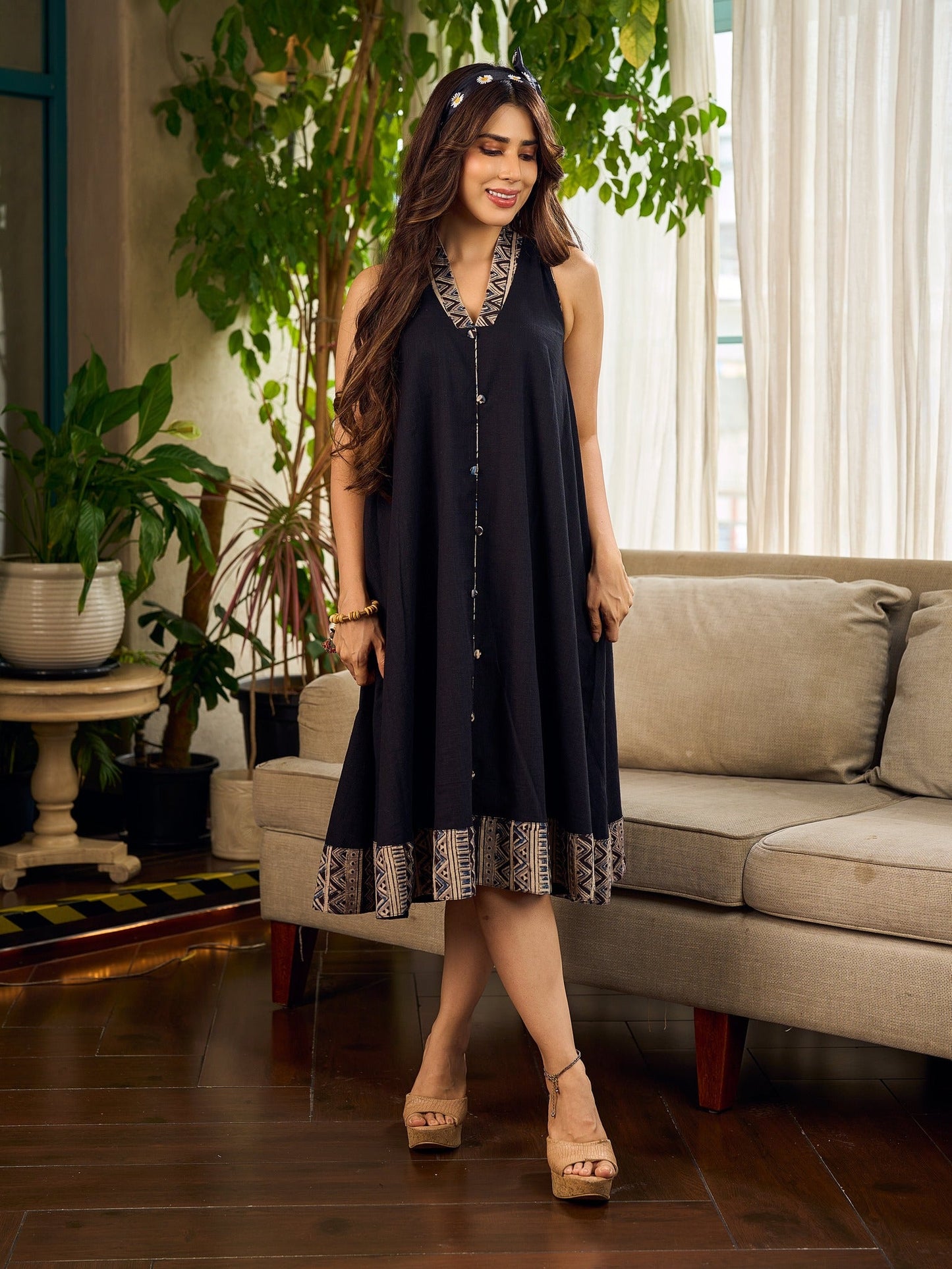 Modern black bias-cut dress showcasing unique artisan-inspired Kalamkari neck trim.
