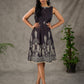 Black digital printed sleeveless dress with straight printed strip neckline and beige accents