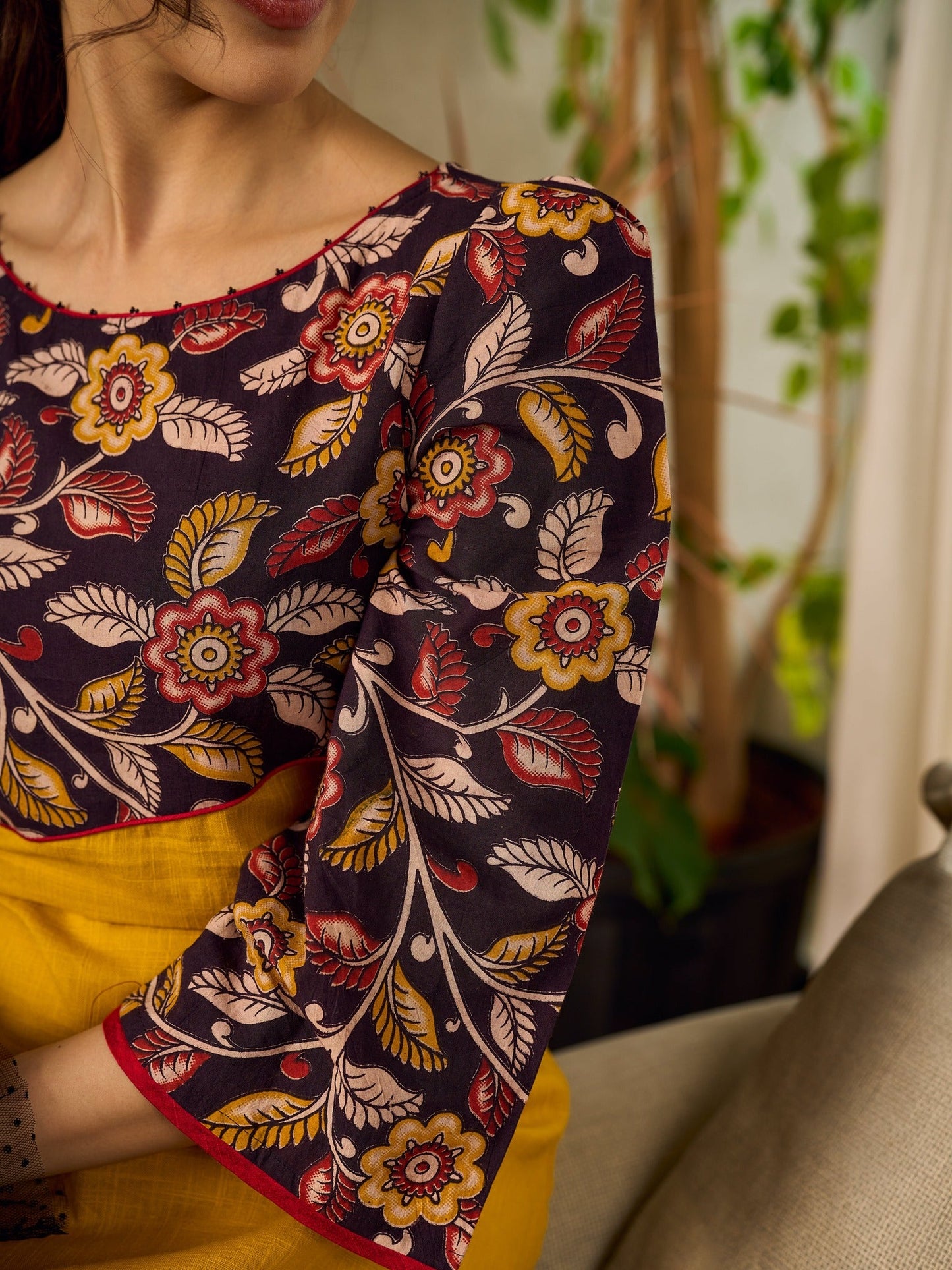 Mustard Kalamkari dress with an asymmetrical yoke and puffed sleeves.