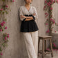 Black Jaipur floral printed yoke top featuring black pintuck body, three-quarter sleeves, and delicate ruffled sleeve edging.