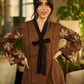 Brown block print dress with floral block printed flared sleeves, black tie-up neckline, and contrast black accents for an effortless, elegant everyday look.