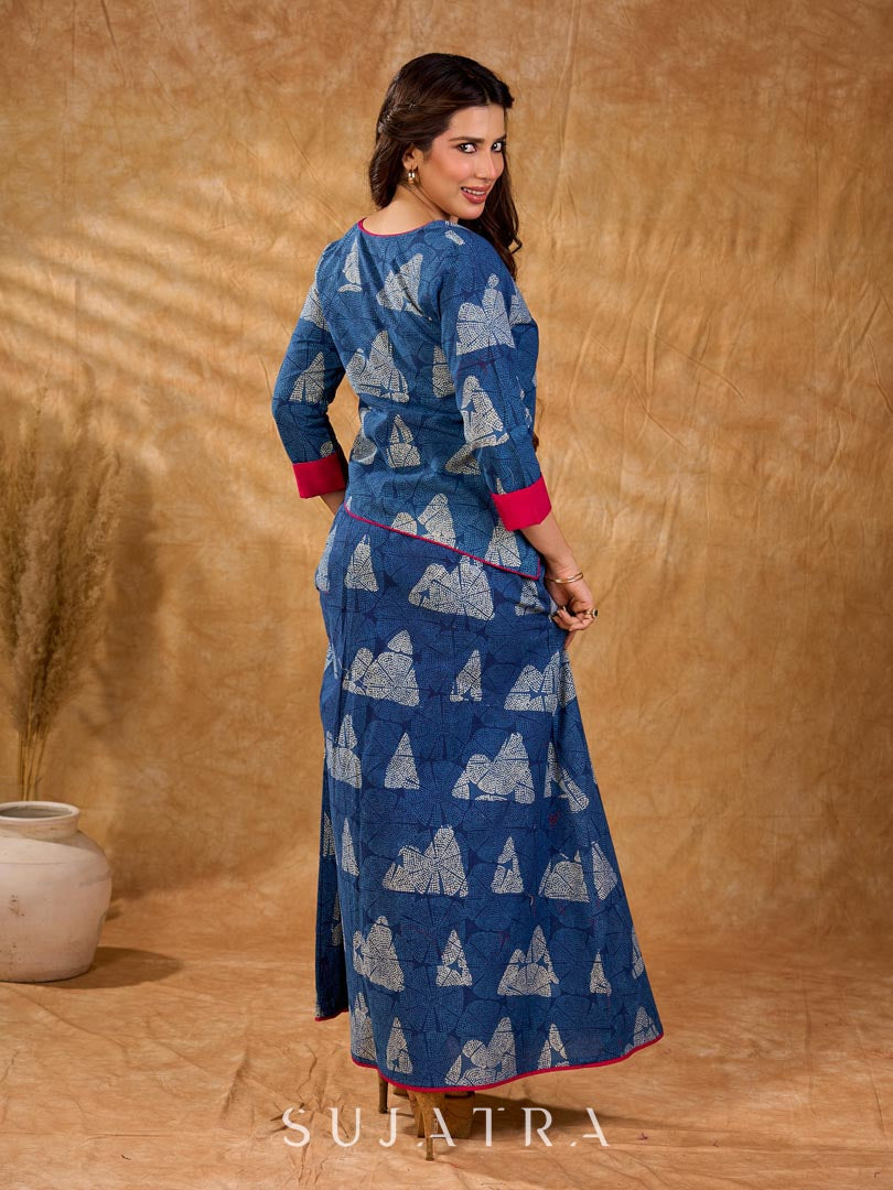 Deep indigo jacket with an asymmetric front closure, magenta folded cuffs, and coordinated accents, offering a structured silhouette with bold contrast and a refined look for elevated corporate styling.
