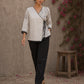Black and white printed crossover top with contrast polka dots, lace-trimmed sleeves, side tie, tassels, and scalloped hem.