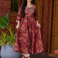 Exquisite deep maroon printed kurta with a graceful bias silhouette, intricate handwork on the yoke, and scalloped sleeve detailing.