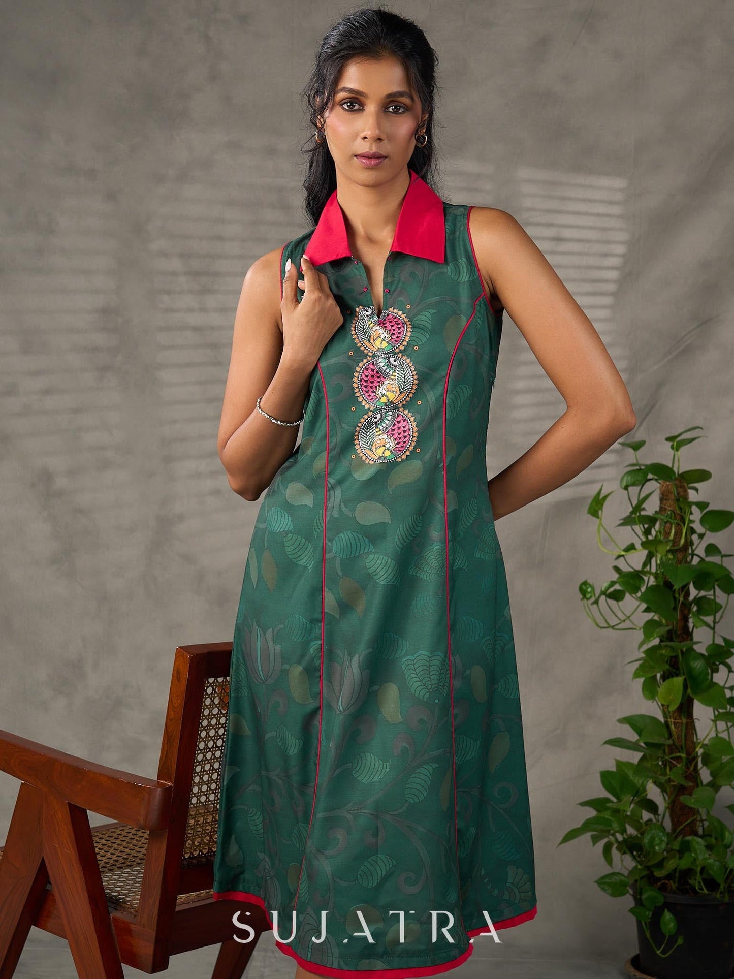 Bottle green Madhubani printed dress with vibrant magenta accents.