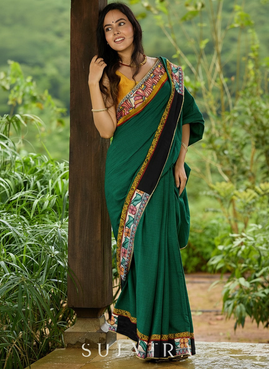 Artisanal cotton saree in bold green with Madhubani hand painted charm