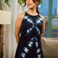 Black tie dye contemporary sleeveless dress with a bold, symmetrical dye pattern.