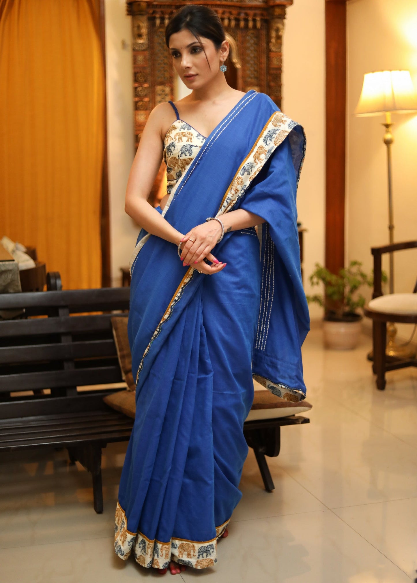 Bright blue Cotton saree with elephant print border and white lines