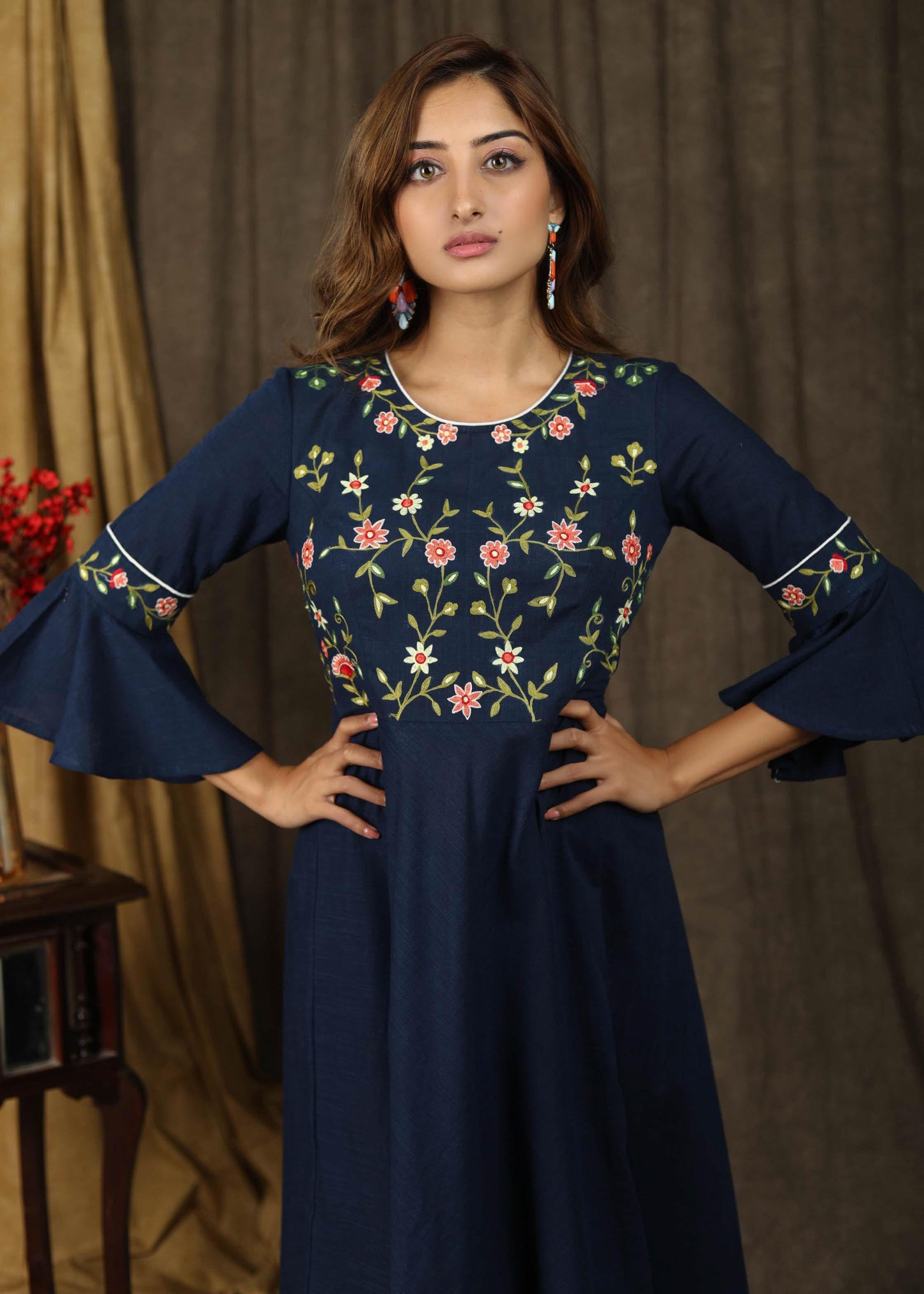 Classic navy blue gathered dress with bell sleeves and minimal floral embroidery
