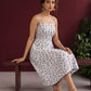 White Cotton Fit & Flare Midi Dress with Black Feather Print and Double Strap Detail — seated
