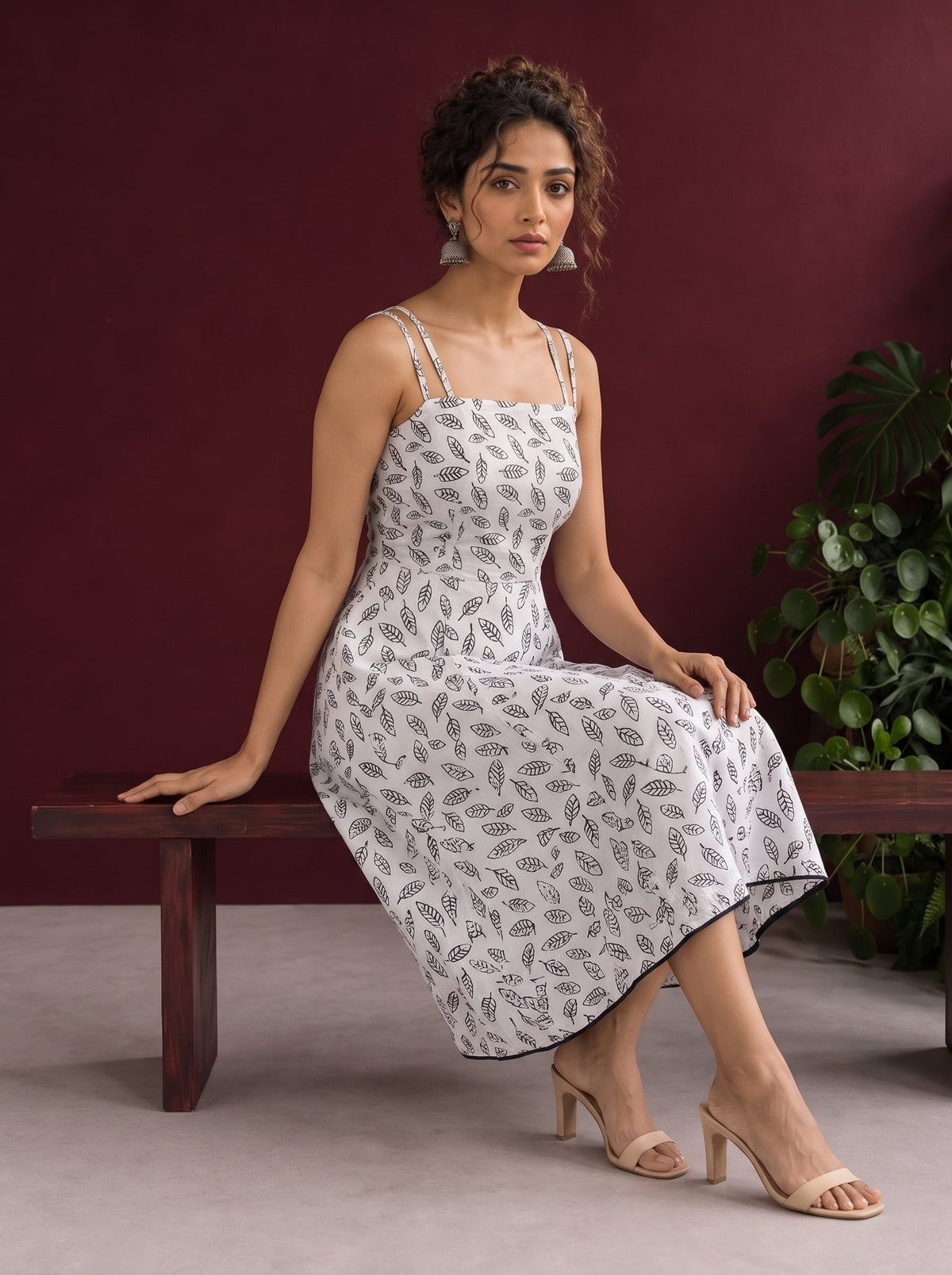 White Cotton Fit & Flare Midi Dress with Black Feather Print and Double Strap Detail — seated