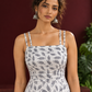 White Cotton Fit & Flare Midi Dress with Black Feather Print and Double Strap Detail — fabric detail