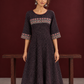 Elegant Black Ajrakh Polka Dot Printed Dress with Maroon Ajrakh Floral Border Yoke and Matching Sleeve Cuffs — styled view