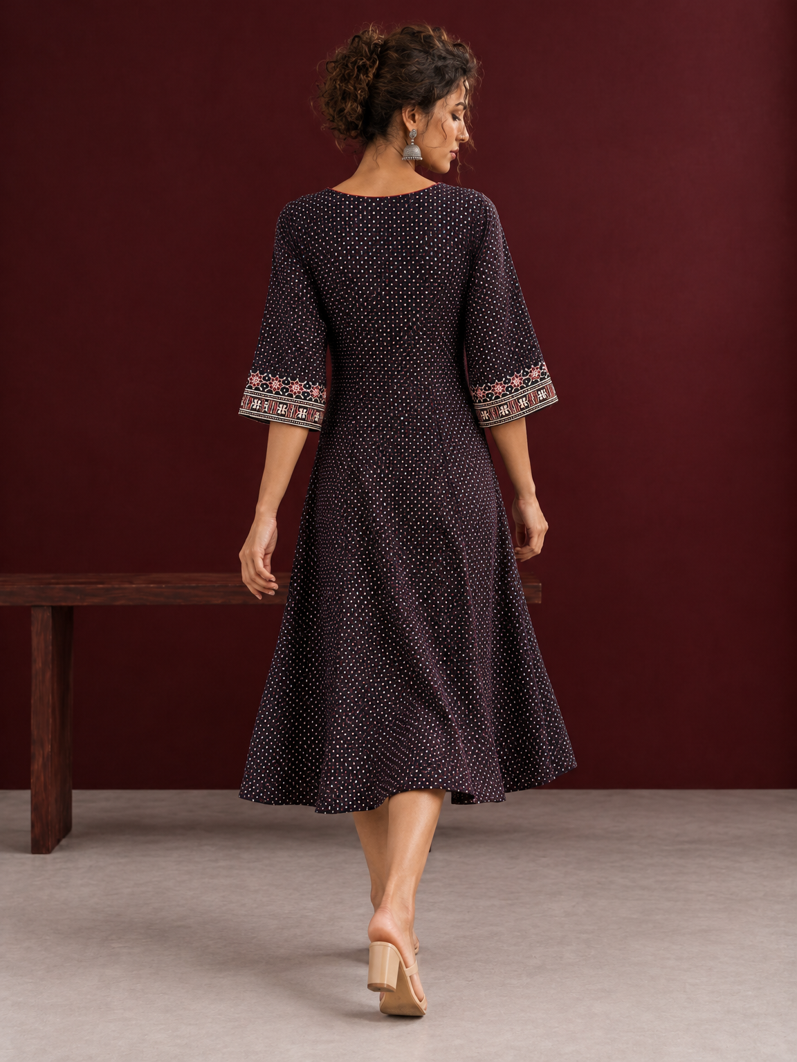 Elegant Black Ajrakh Polka Dot Printed Dress with Maroon Ajrakh Floral Border Yoke and Matching Sleeve Cuffs — back view