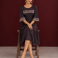 Elegant Black Ajrakh Polka Dot Printed Dress with Maroon Ajrakh Floral Border Yoke and Matching Sleeve Cuffs — seated