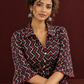Bold Black Ajrakh Cotton Shirt Dress with Red & Beige Zigzag Print and Kantha Detailing — seated detail