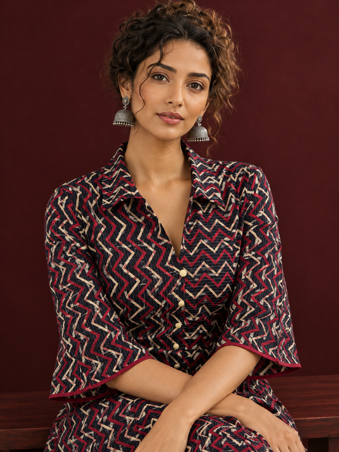 Bold Black Ajrakh Cotton Shirt Dress with Red & Beige Zigzag Print and Kantha Detailing — seated detail