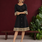Elegant Black Cotton A-Line Dress with Madhubani Print Border Hem and Matching Bell Sleeve Cuffs — front view