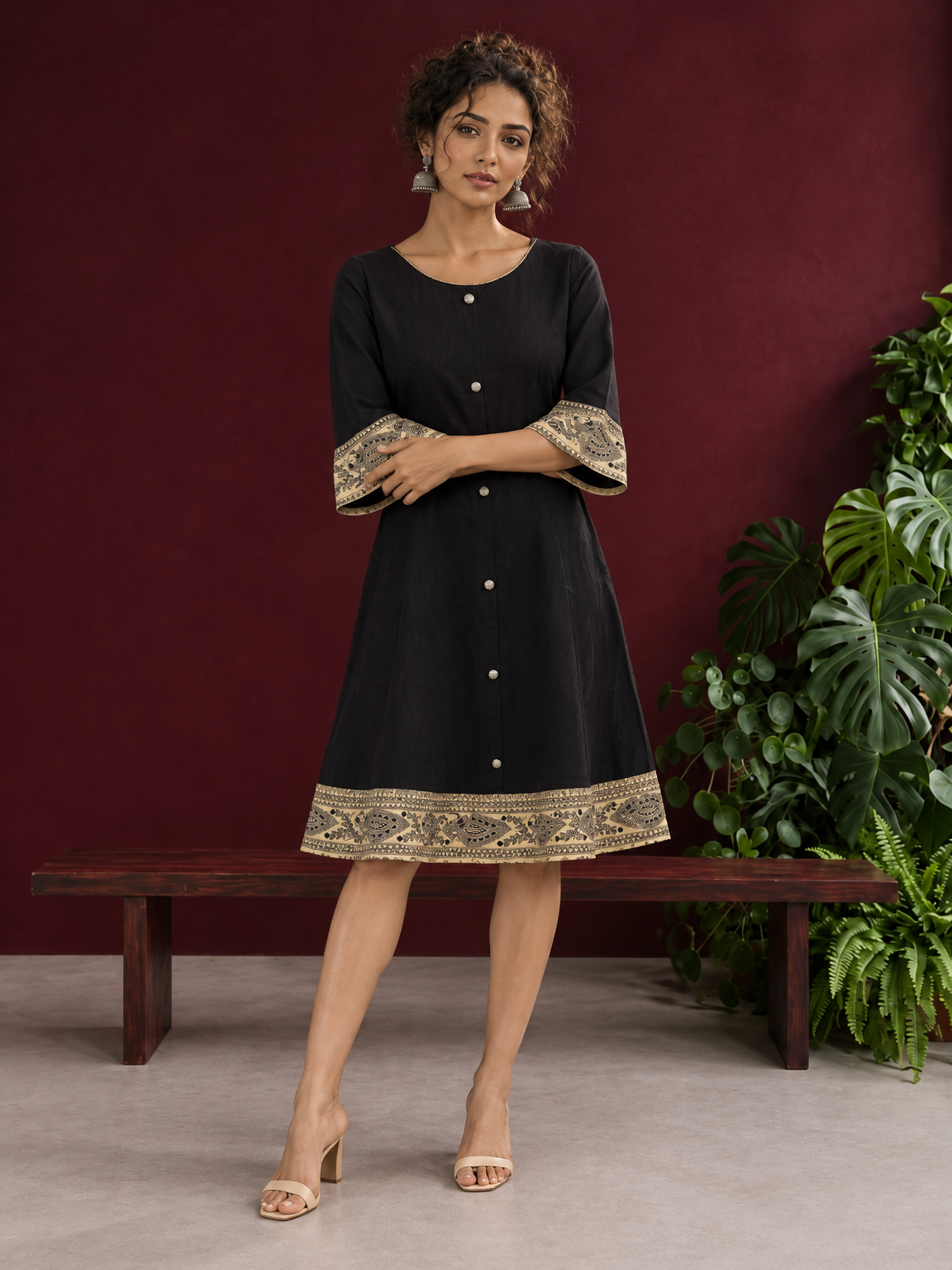 Elegant Black Cotton A-Line Dress with Madhubani Print Border Hem and Matching Bell Sleeve Cuffs — front view