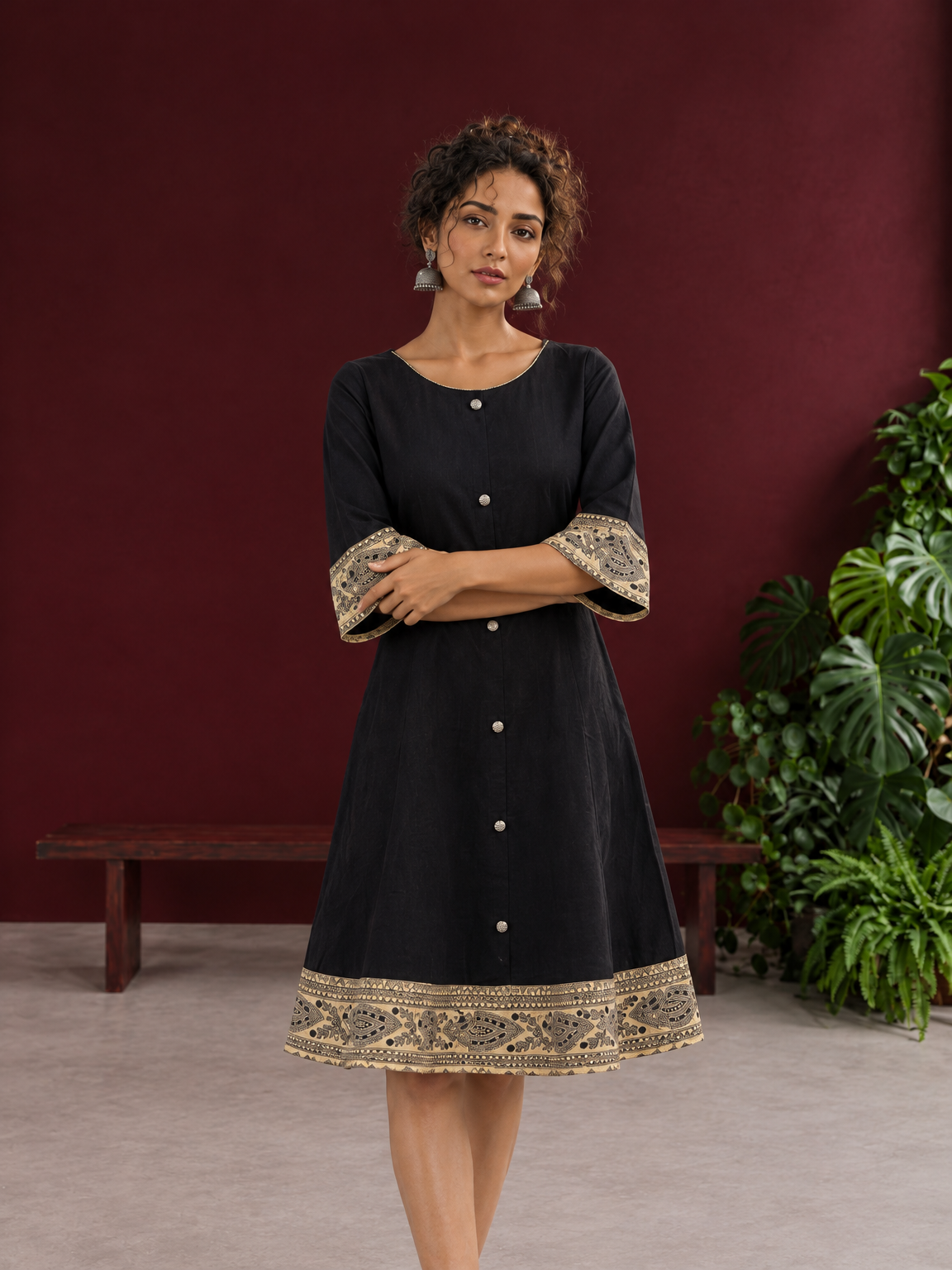 Elegant Black Cotton A-Line Dress with Madhubani Print Border Hem and Matching Bell Sleeve Cuffs — styled view