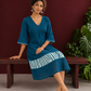 Teal Blue Cotton Dress with Abstract Print Hem Panel and Sleeve Cuffs — seated