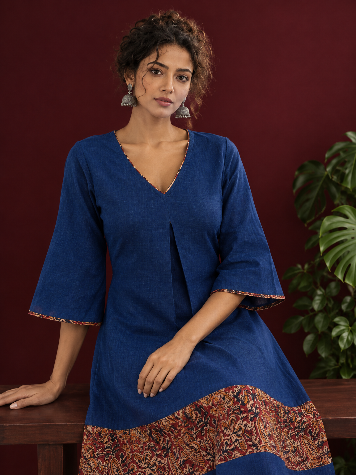 Timeless Navy Blue Cotton Dress with Kalamkari Print Hem Border & Contrast Neckline and Cuff Trim — seated detail