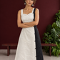 Elegant Off-White Cotton A-Line Dress with Contrast Black Pinstripe Side Panel & Button Detailing — styled view