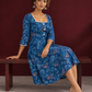 Classic Blue Cotton One Piece Dress with Printed Leaf Motifs & Lace Trim Square Neck — seated
