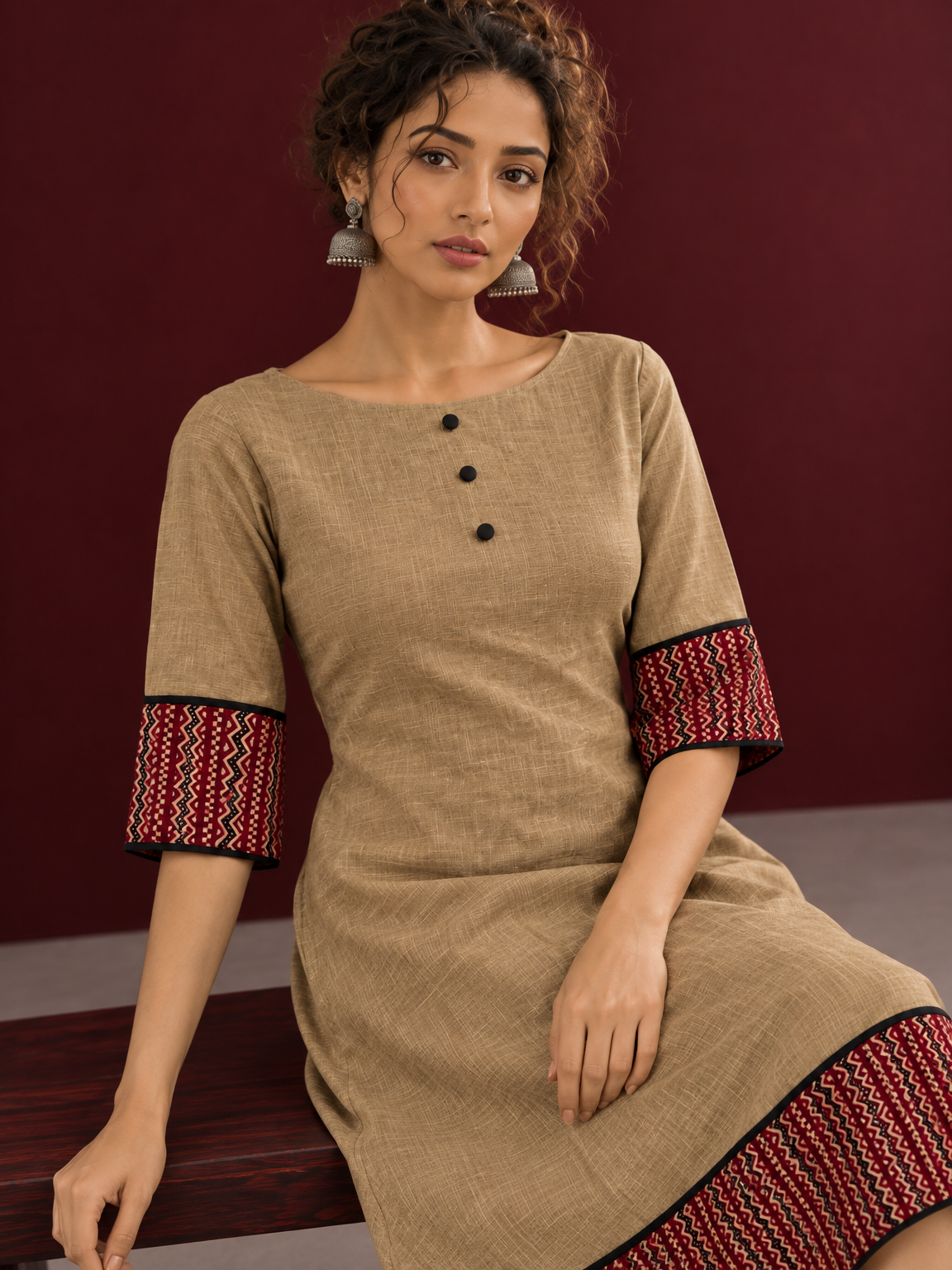 Timeless Beige Cotton A-Line Dress with Maroon Zigzag Print Sleeve Cuffs & Hem Border — seated detail