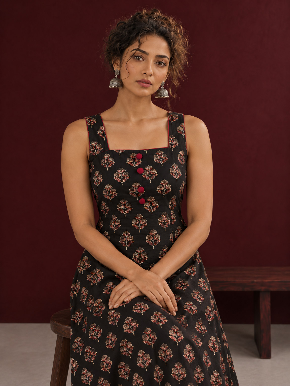 Classic Black Ajrakh Cotton Sleeveless Dress with Floral Print and Maroon Piping Square Neckline — seated detail