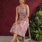 Elegant White Cotton Floral Print A-Line Dress with Maroon Piping and Button Detailing — seated