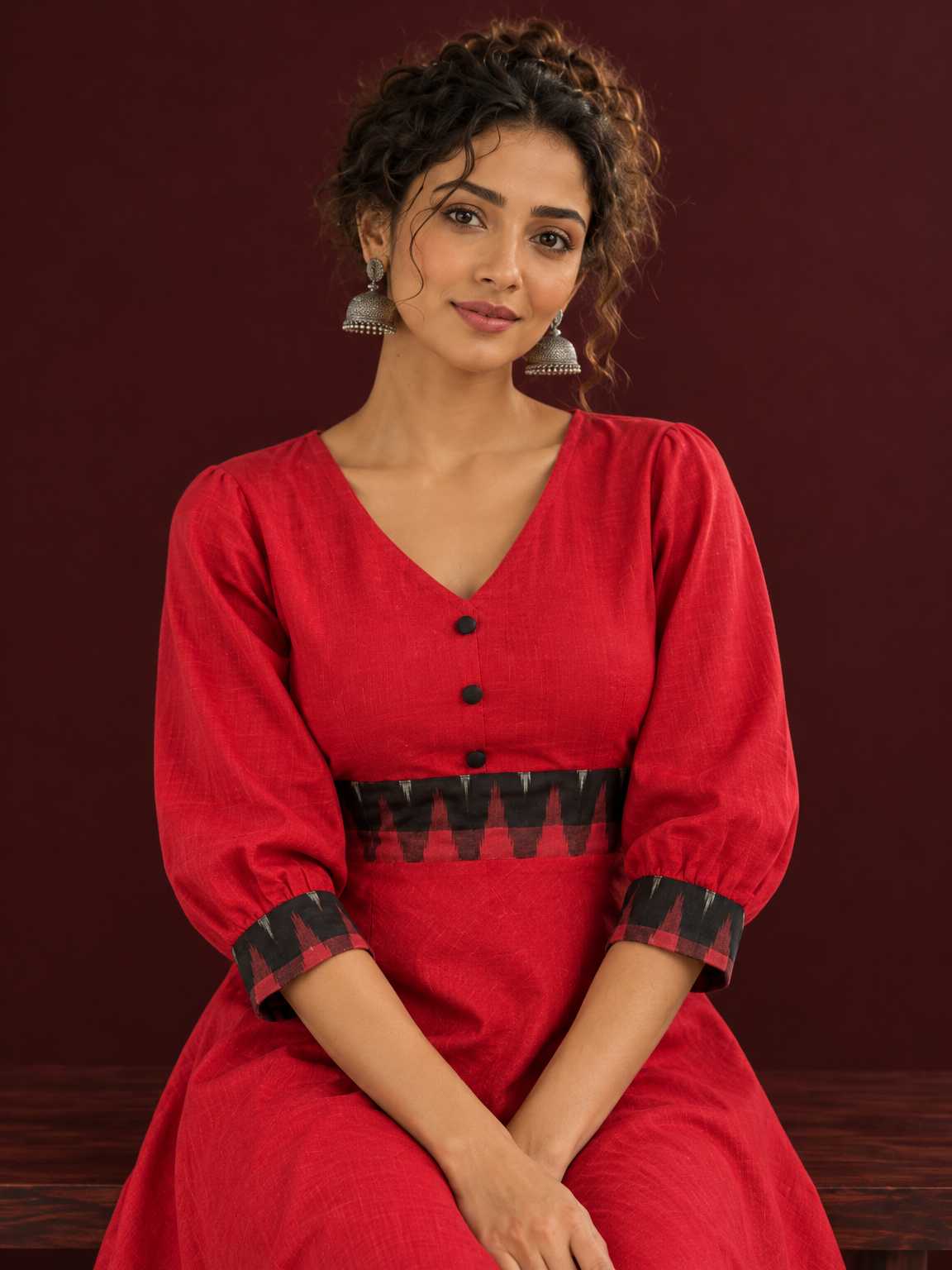 Vibrant Red Cotton Fit & Flare Dress with Contrast Black Ikat Waistband & Matching Cuffs — seated detail