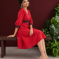 Vibrant Red Cotton Fit & Flare Dress with Contrast Black Ikat Waistband & Matching Cuffs — seated