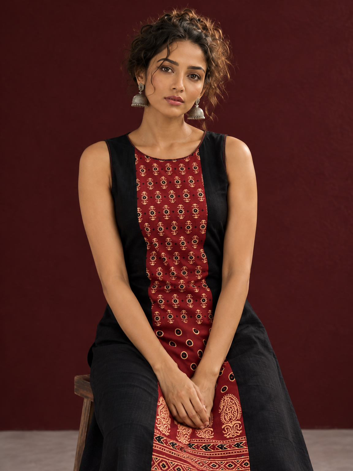 Timeless Black Cotton A-Line Dress with Maroon Ajrakh Print Center Panel & Contrast Piping — seated detail