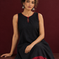 Classic Black Cotton Silk Dress with Keyhole Neckline and Contrast Maroon Ruffle Hem — seated detail