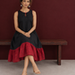 Classic Black Cotton Silk Dress with Keyhole Neckline and Contrast Maroon Ruffle Hem — seated