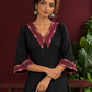 Classic Black Cotton A-line Dress with Contrast Maroon Ikat Collar and Matching Sleeve Cuffs — styled view