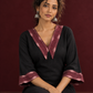 Classic Black Cotton A-line Dress with Contrast Maroon Ikat Collar and Matching Sleeve Cuffs — seated detail
