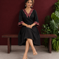 Classic Black Cotton A-line Dress with Contrast Maroon Ikat Collar and Matching Sleeve Cuffs — seated