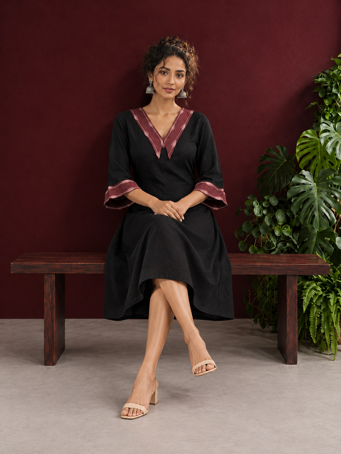 Classic Black Cotton A-line Dress with Contrast Maroon Ikat Collar and Matching Sleeve Cuffs — seated
