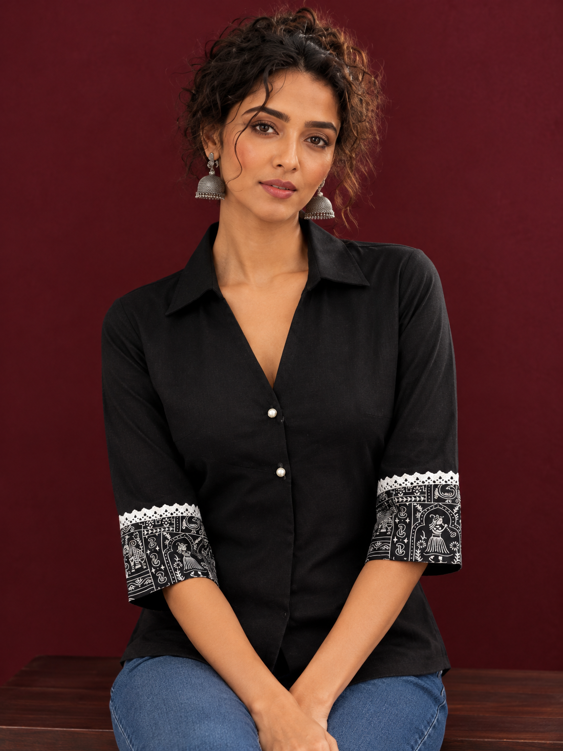 Classic Black Cotton Shirt with Collared Neckline and Contrast Printed Sleeve Cuffs — seated detail