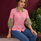 Vibrant Pink Cotton Shirt with Contrast Green Floral Print Collar and Balloon Sleeves — seated