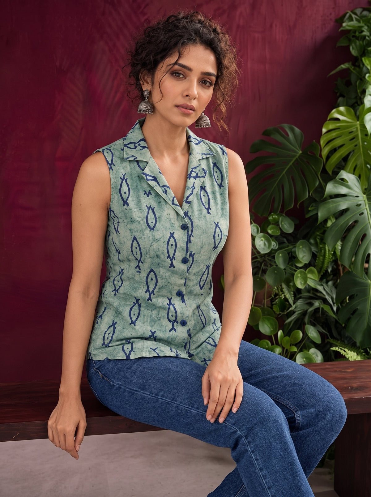 Blue Printed Cotton Sleeveless Shirt with Fish Motif & Collared Neckline — seated