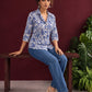 Classic White Cotton Shirt with Allover Blue Floral Print & Collared Neckline — seated