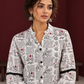 White Cotton Shirt with Warli Print, Mandarin Collar & Crochet Trimmed Full Sleeves — fabric detail